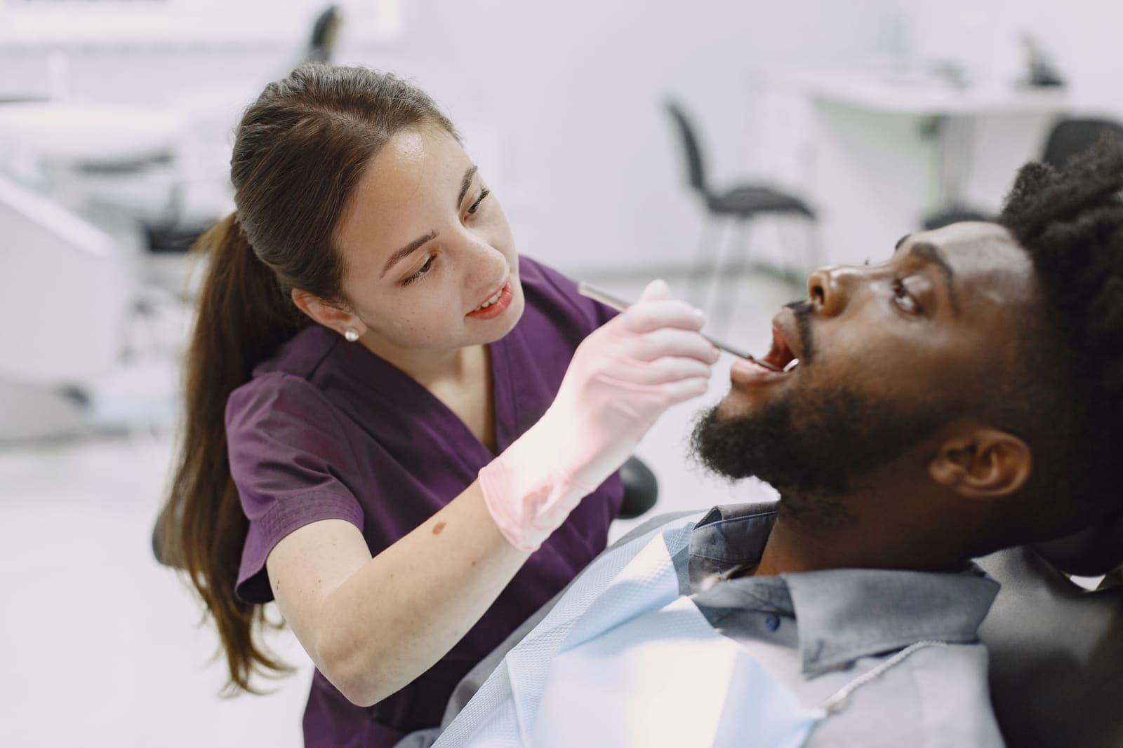 A dentist examines a patient's teeth during a routine checkup.