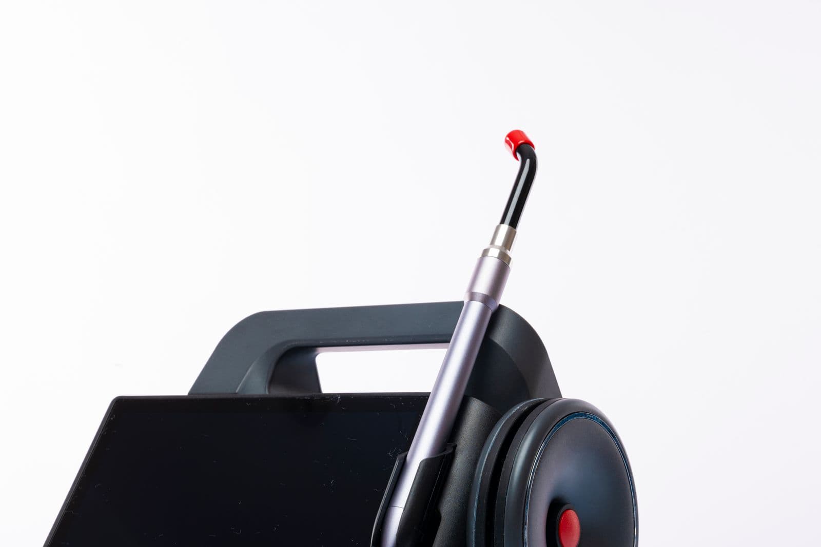 A dental laser machine with a control screen and handpiece.